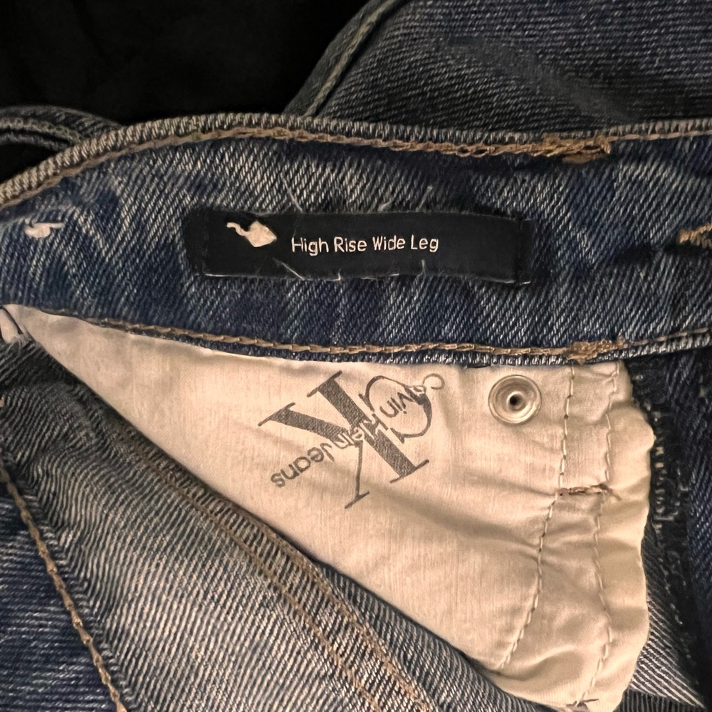 Calvin Klein high rise wide blue wash denim with denim belt attached.
